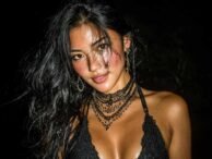 Glamorous woman with dark hair and statement jewelry, possibly a KL escort.