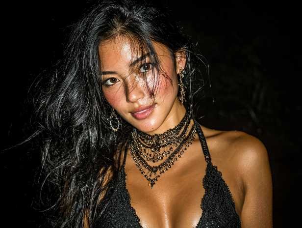 Glamorous woman with dark hair and statement jewelry, possibly a KL escort.