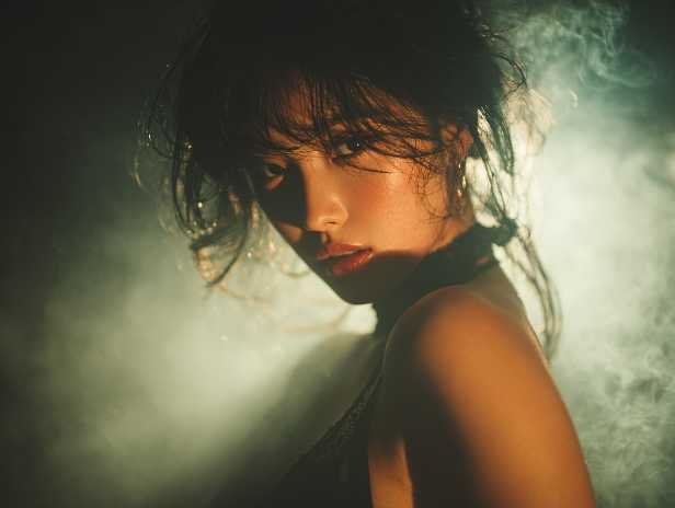 Sultry Asian woman with smoky background, possibly related to KL Escort services.