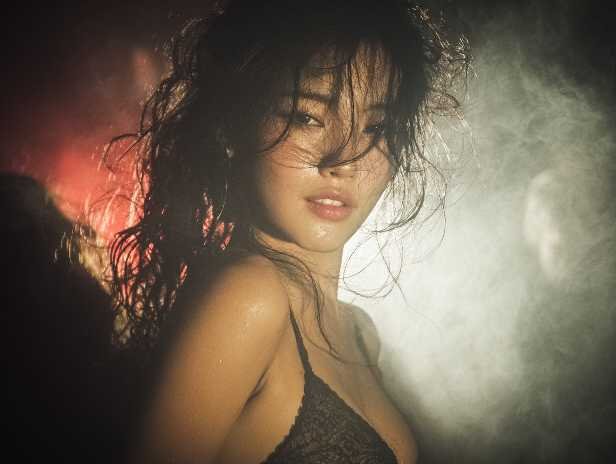 Sensual woman with wet hair and lace bra, Kuala Lumpur escort services.