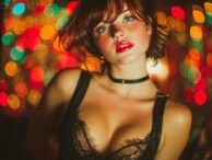 Attractive woman with red lips and freckles wearing a black lace top. Kuala Lumpur escort photography.