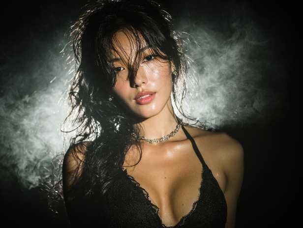 Attractive woman with wet hair and a black lace top, possibly related to KL escort services.