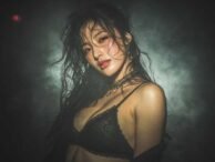 Sultry woman in lingerie with wet hair, suggestive of Kuala Lumpur escort services.
