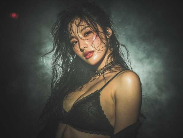 Sultry woman in lingerie with wet hair, suggestive of Kuala Lumpur escort services.