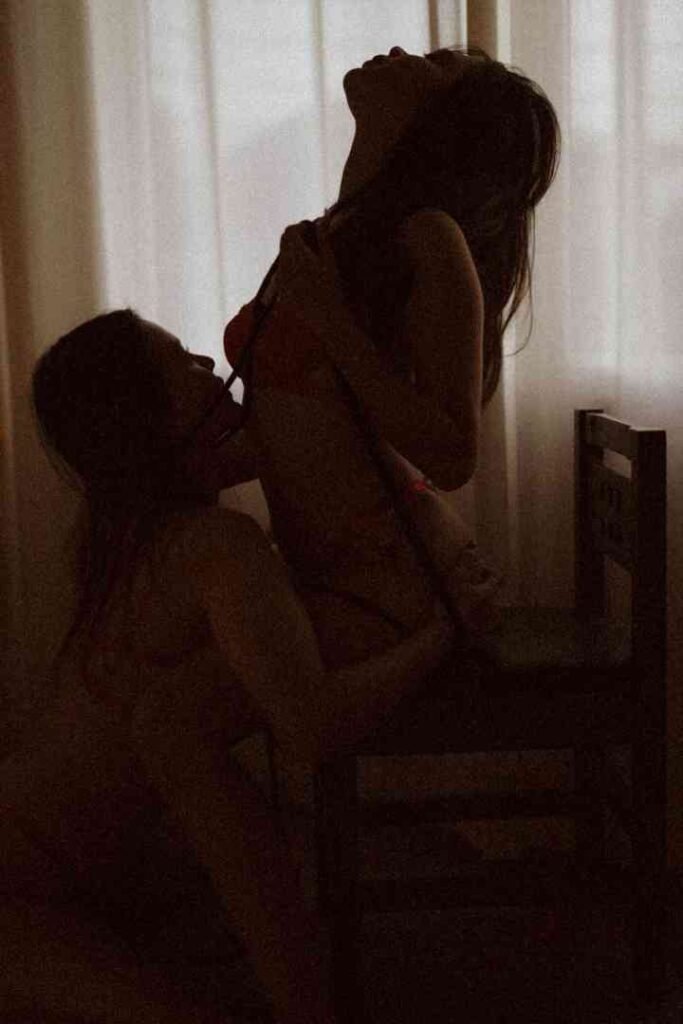Viola and Cici in an intimate moment, silhouetted against a window