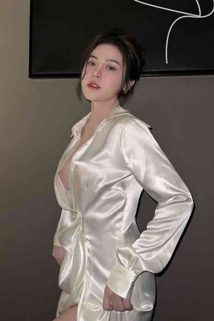 Tina, a 23yo Malay woman with C cups, in a white satin dress