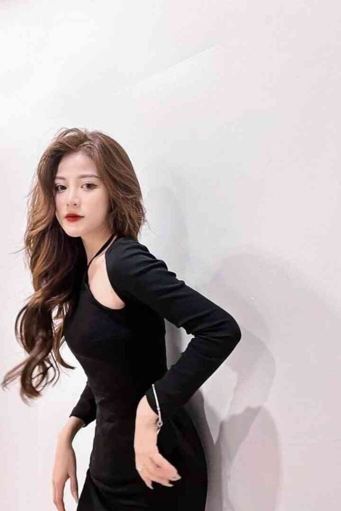 Tina, 23yo local Malay escort in KL, wears a black dress with long sleeves