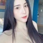Young woman with long dark hair and a pink top