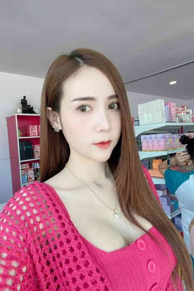 Amy, a 23-year-old Thai escort with C-cup breasts, in a pink outfit.