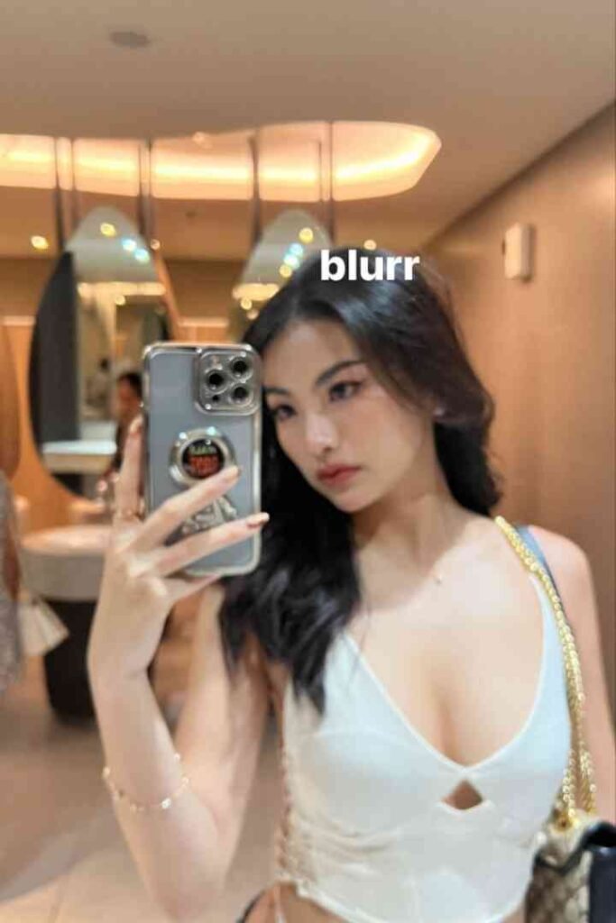 Dewi, 22yo local Malay escort, takes selfie in bathroom mirror