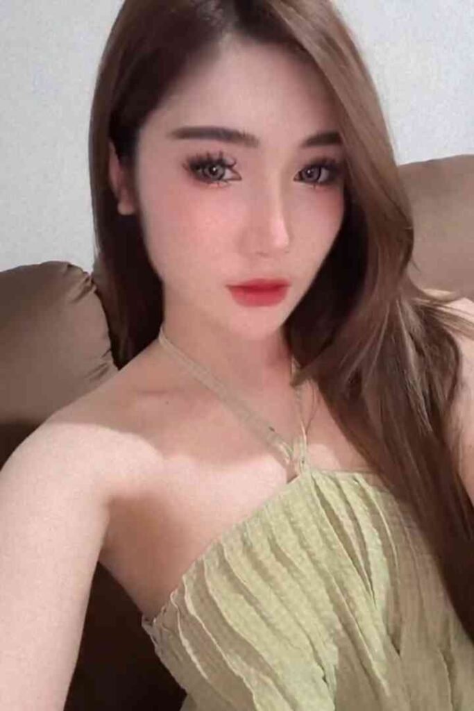 Kenzo, a 23-year-old Malay escort in KL, wearing a green dress and red lipstick
