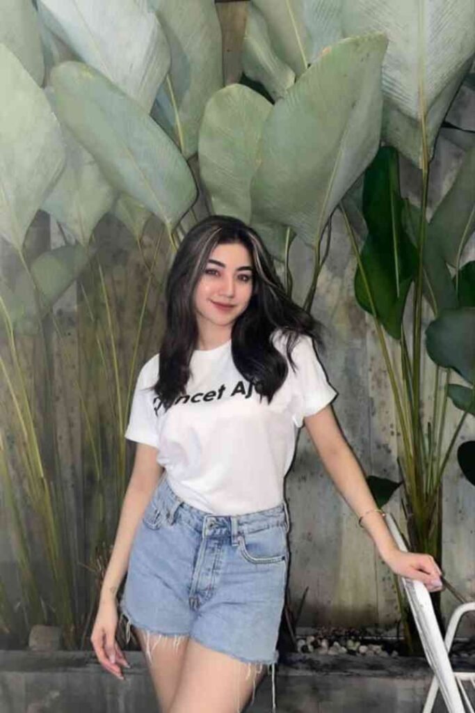 Young woman in white t-shirt and denim shorts