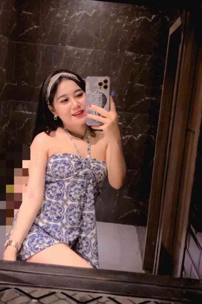 Woman in blue dress taking selfie in Kuchai Lama