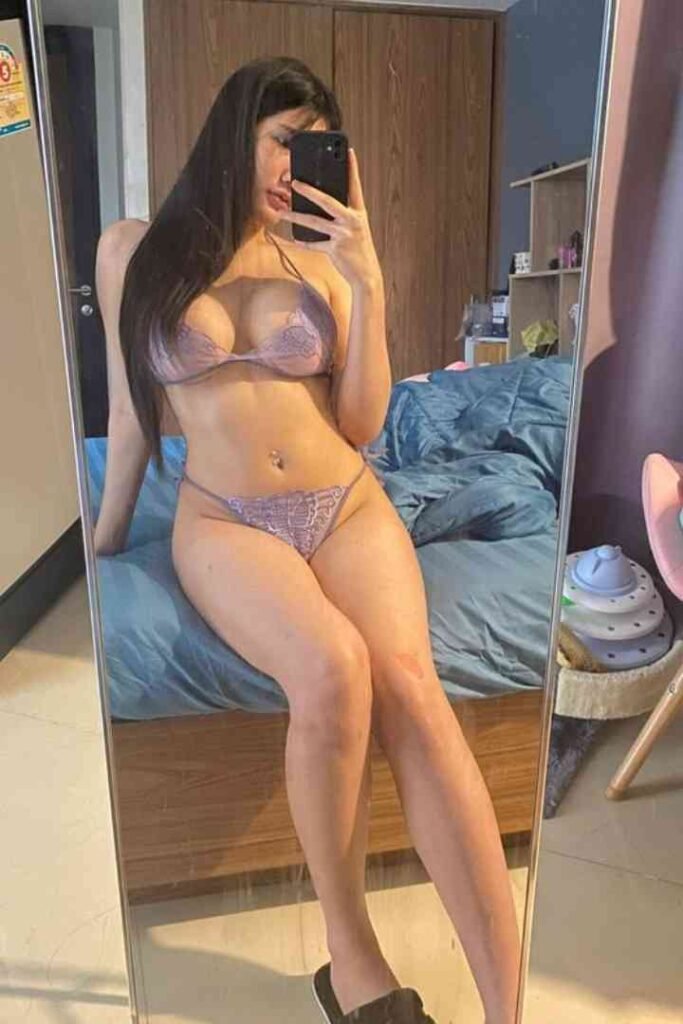 Young Thai woman in lingerie posing for a mirror selfie