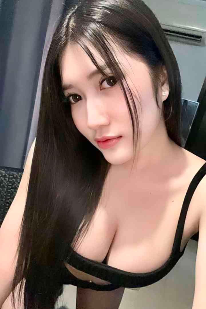 Asian woman with long black hair wearing black strapless bra