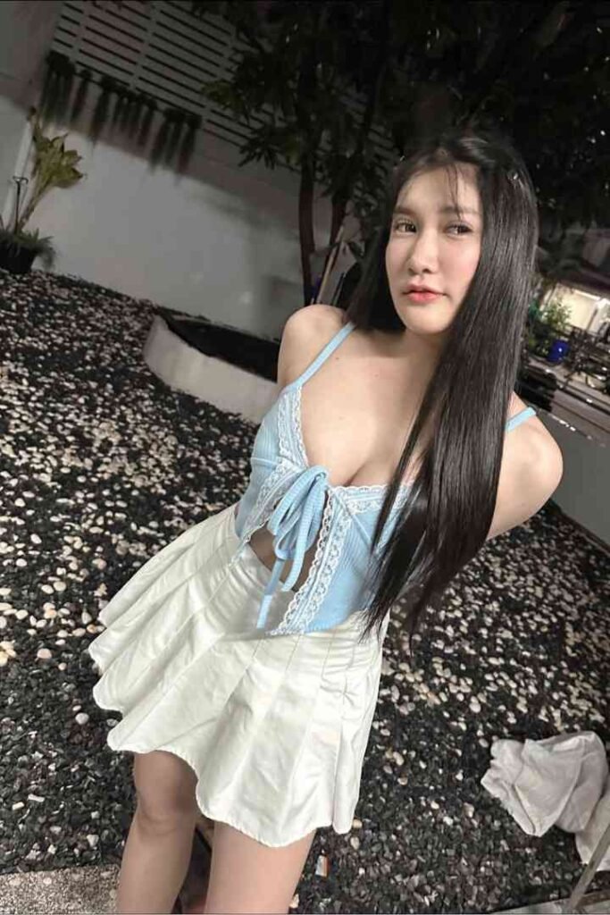 Young Thai woman in light blue top and white skirt