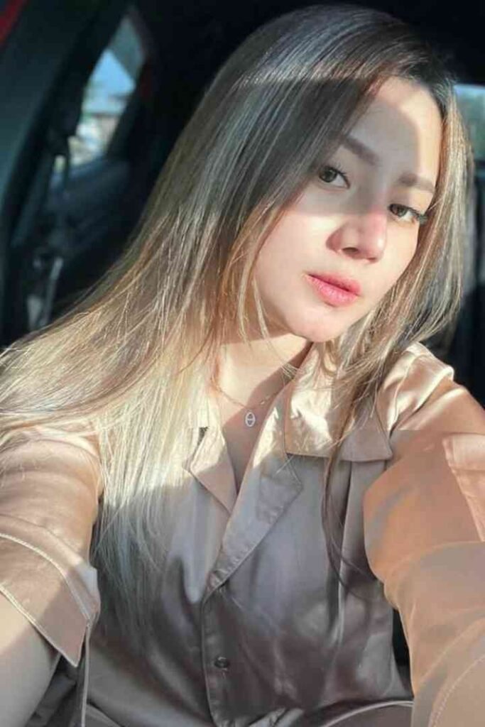 Tasya local escort with long blonde hair in beige shirt