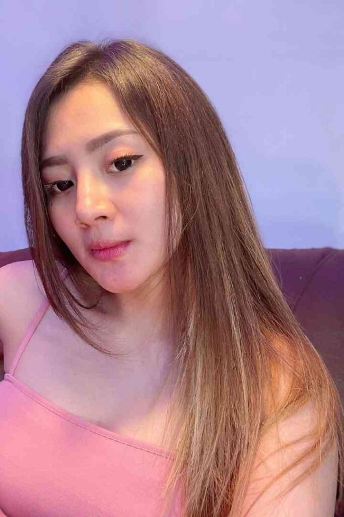 Tasya Malay escort with long brown hair in pink tank top