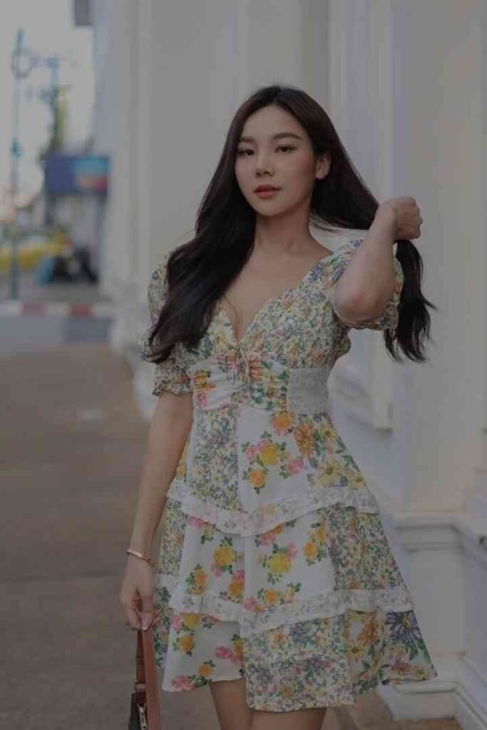 Young woman in a floral dress walking outdoors