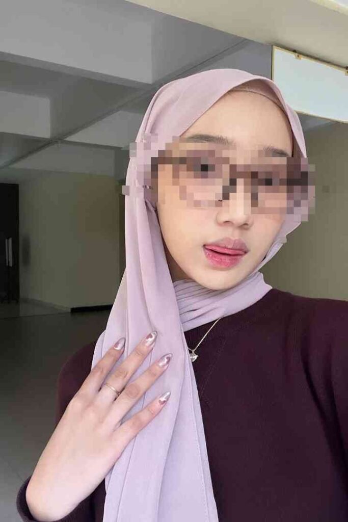 Young woman in hijab and sunglasses, playful expression