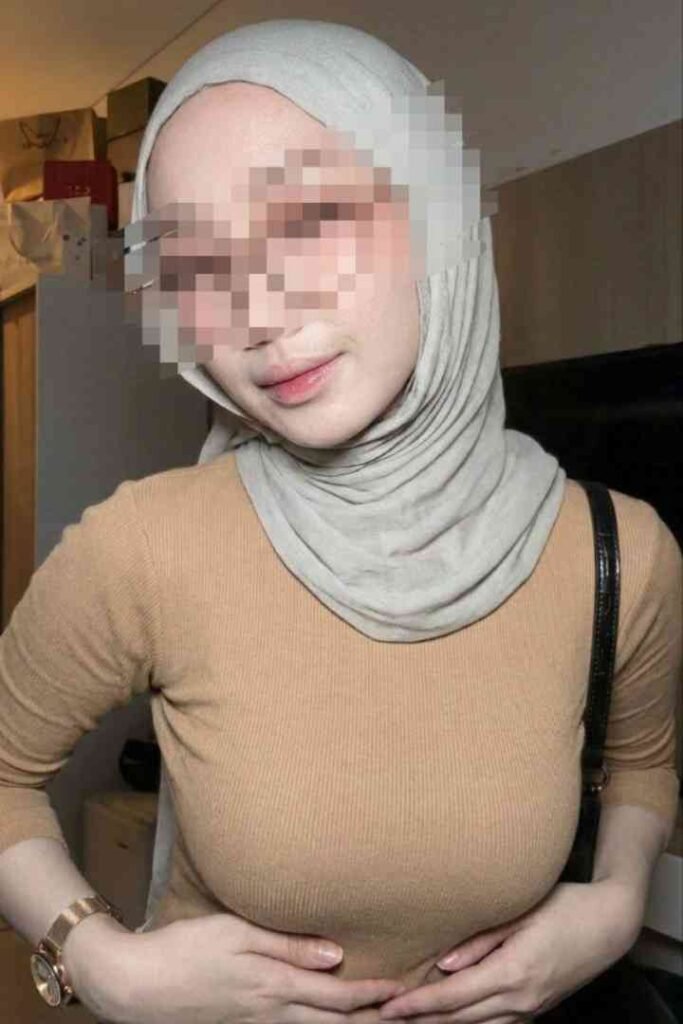Woman in hijab and tan shirt